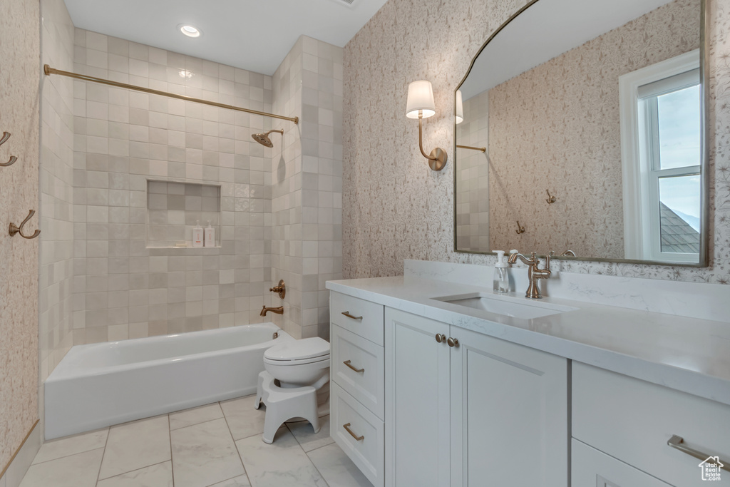 Bathroom featuring vanity, bathtub / shower combination, and toilet