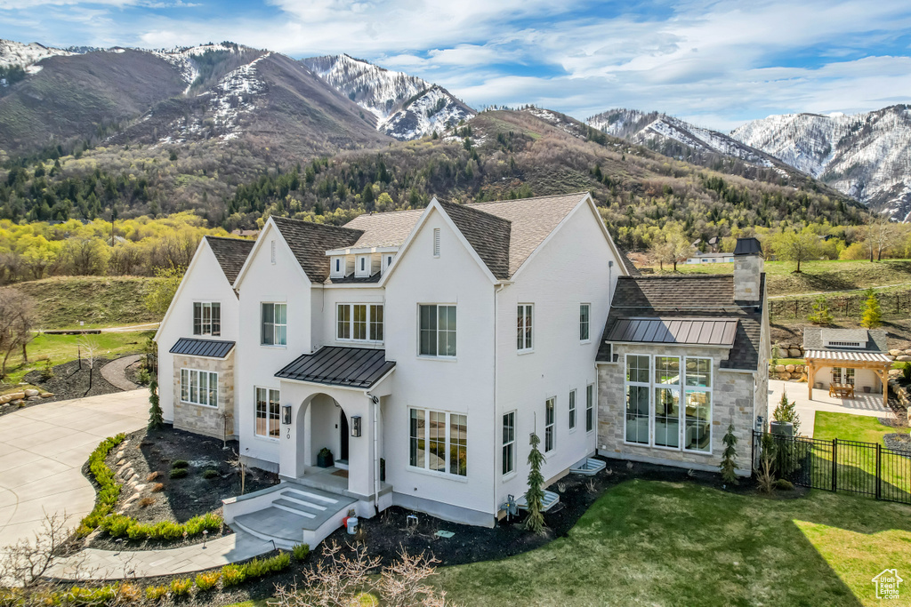 View of front of house featuring a standing seam roof, metal roof, and a mountain view