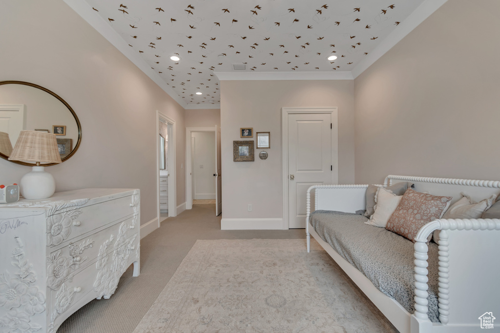 Bedroom featuring light colored carpet, baseboards, and ornamental molding