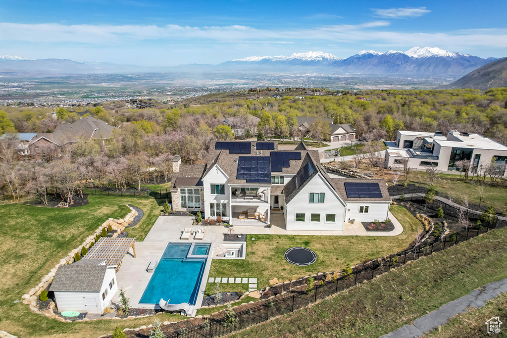 View of subject property featuring a mountain backdrop and a pool area