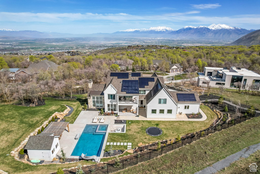 View from above of property with a mountainous background and a pool area