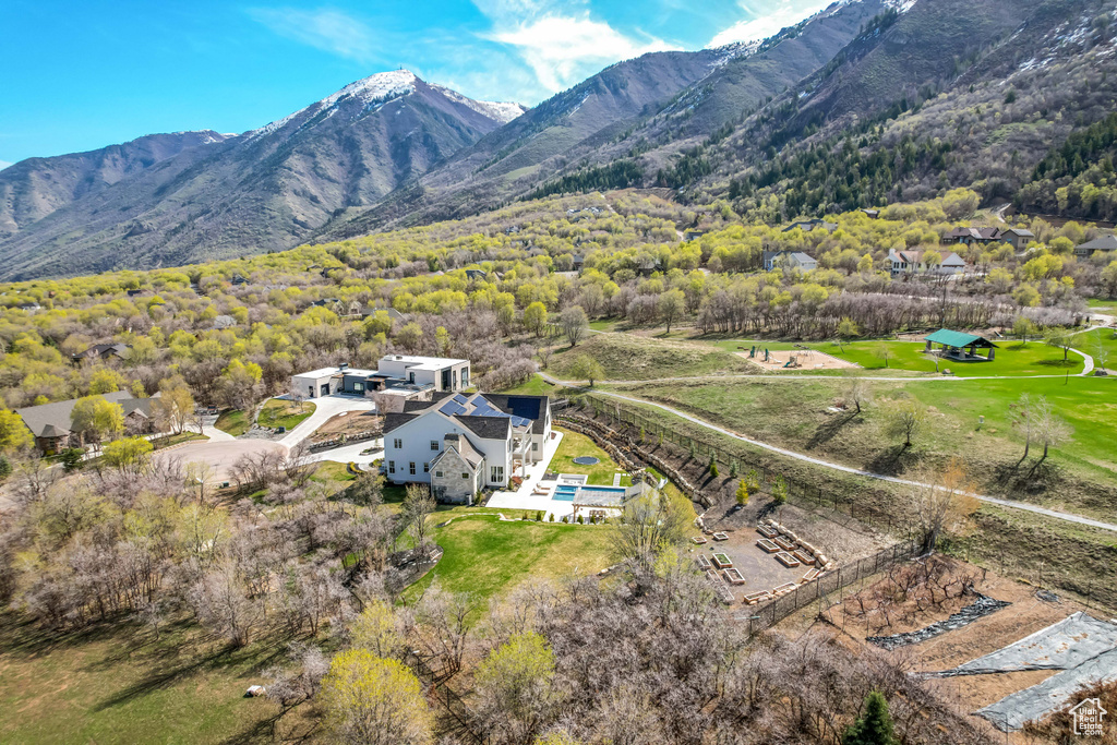 View of subject property featuring mountains and a forest