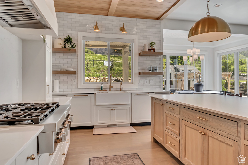 Kitchen with open shelves, stainless steel gas stovetop, a sink, tasteful backsplash, and wooden ceiling