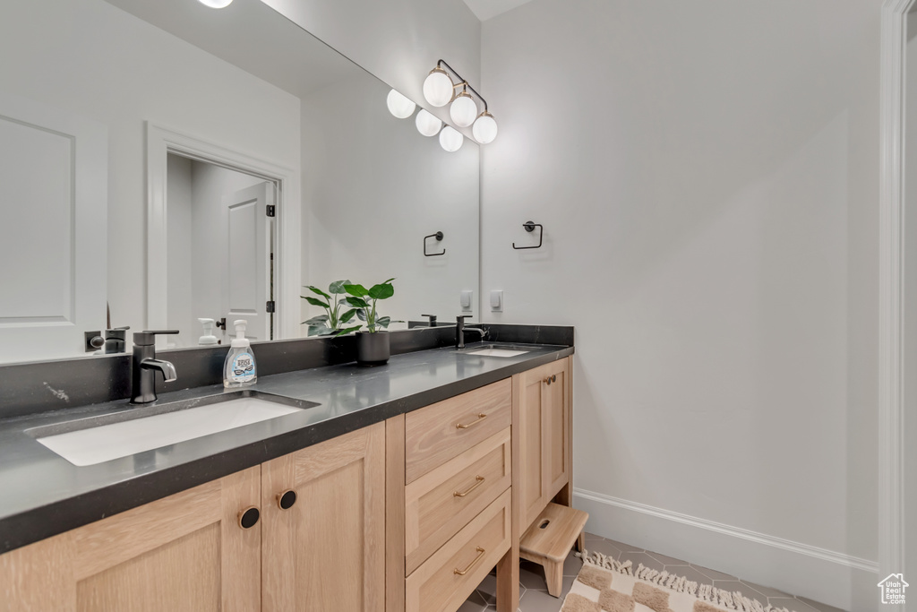 Bathroom featuring double vanity and baseboards