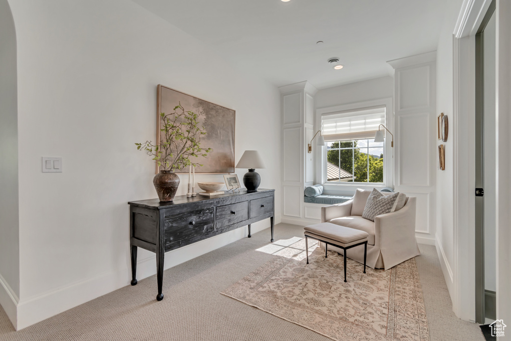 Living area featuring carpet and baseboards
