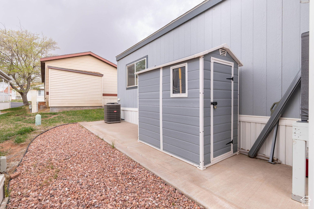 View of outbuilding featuring central air condition unit and an outbuilding