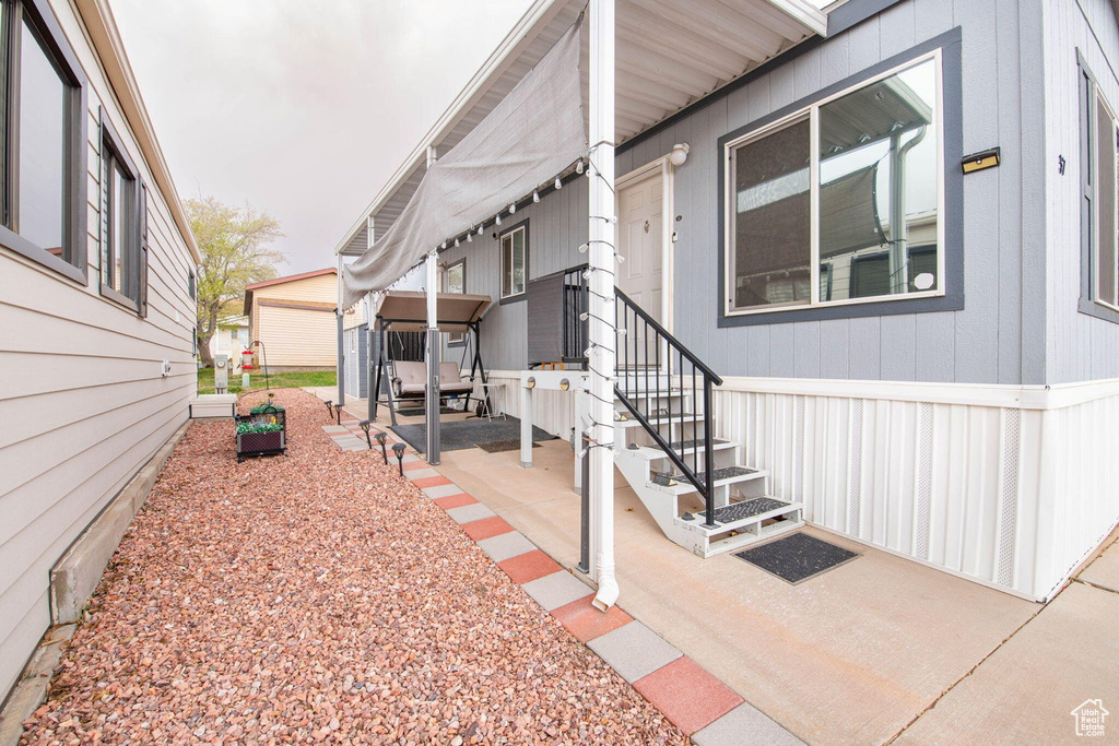 View of side of home featuring a patio area