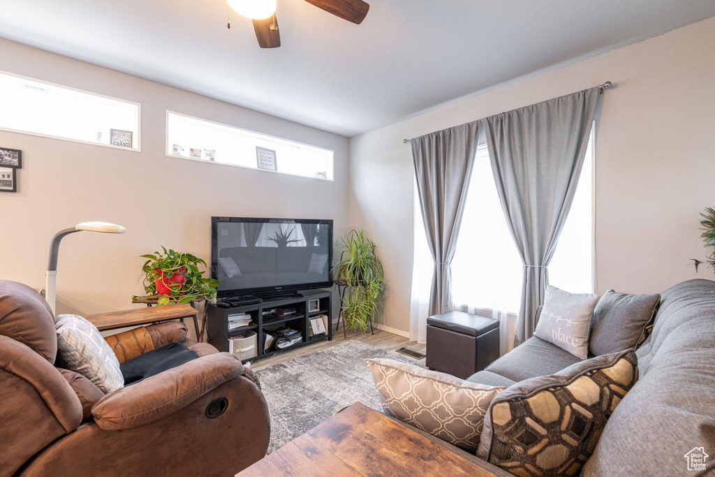 Living area featuring wood finished floors and ceiling fan
