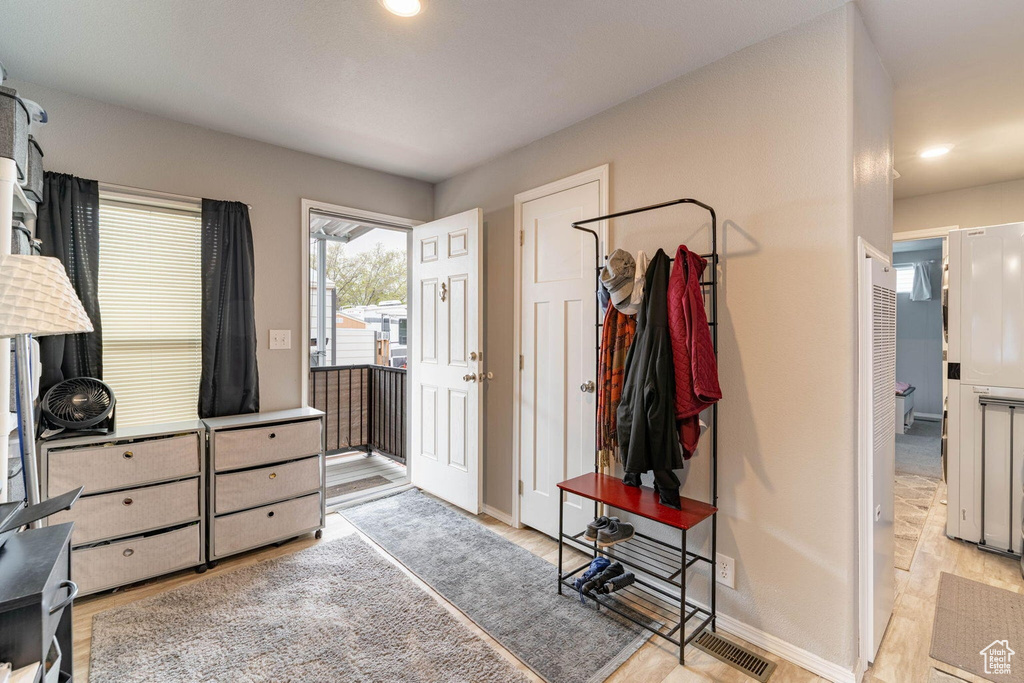 Interior space featuring baseboards, light wood-type flooring, and recessed lighting