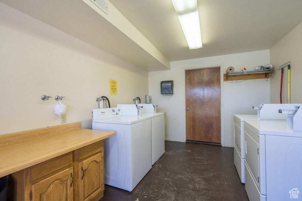 Common laundry area with separate washer and dryer and visible vents