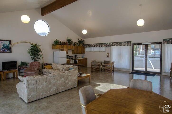 Living room with high vaulted ceiling and beamed ceiling