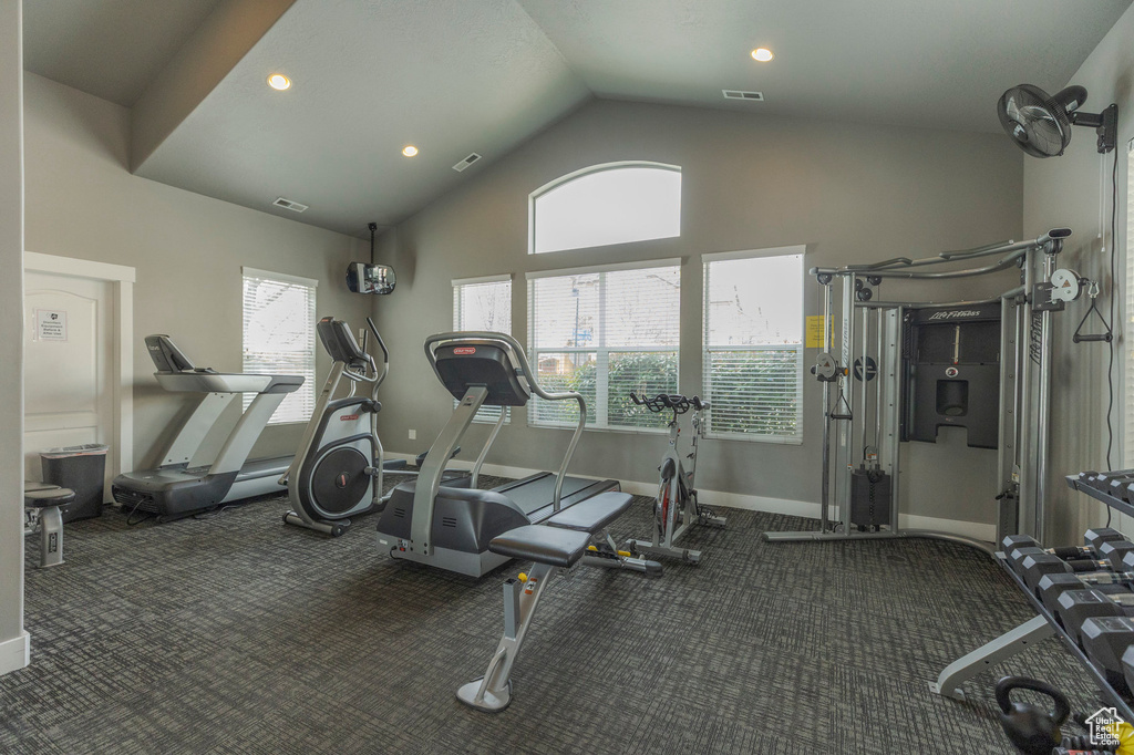 Workout area with visible vents, baseboards, recessed lighting, and lofted ceiling