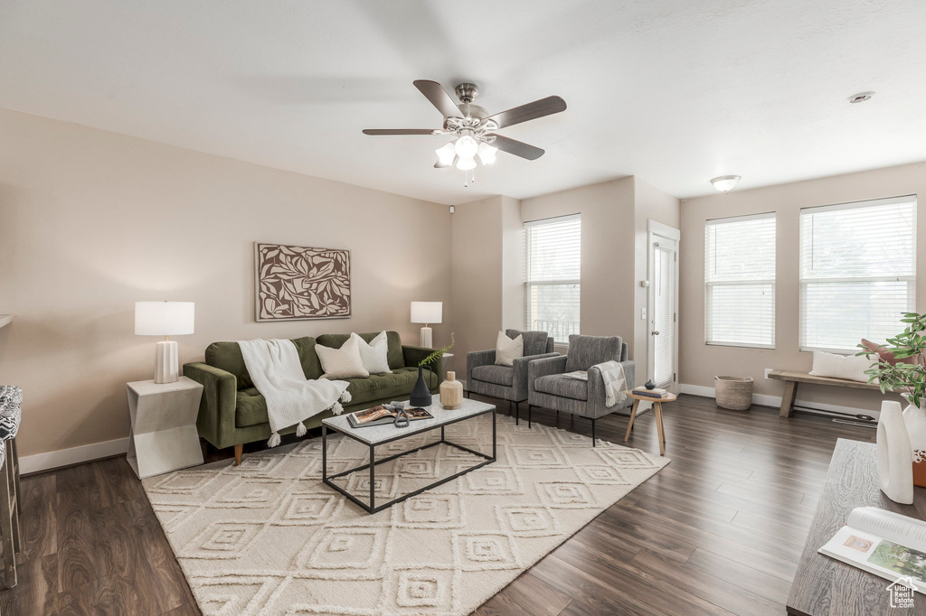 Living room with baseboards, a ceiling fan, and wood finished floors