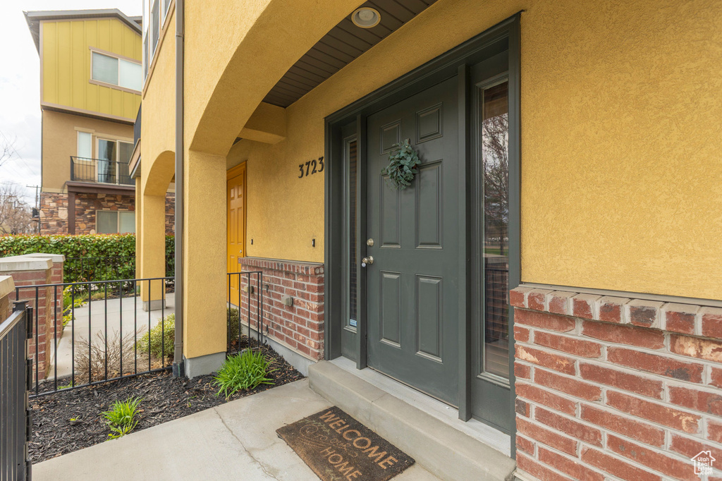 Entrance to property with stucco siding