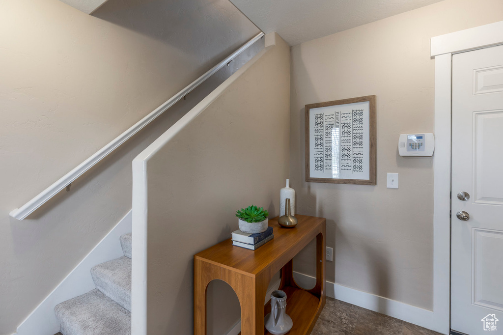 Foyer with stairway and baseboards