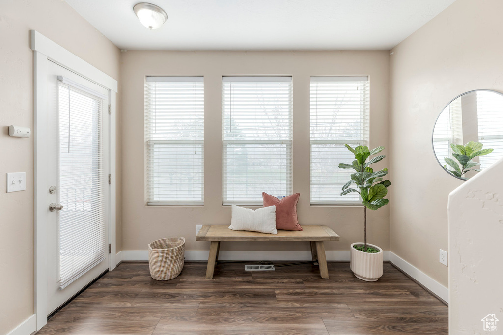 Sitting room featuring visible vents, a wealth of natural light, wood finished floors, and baseboards