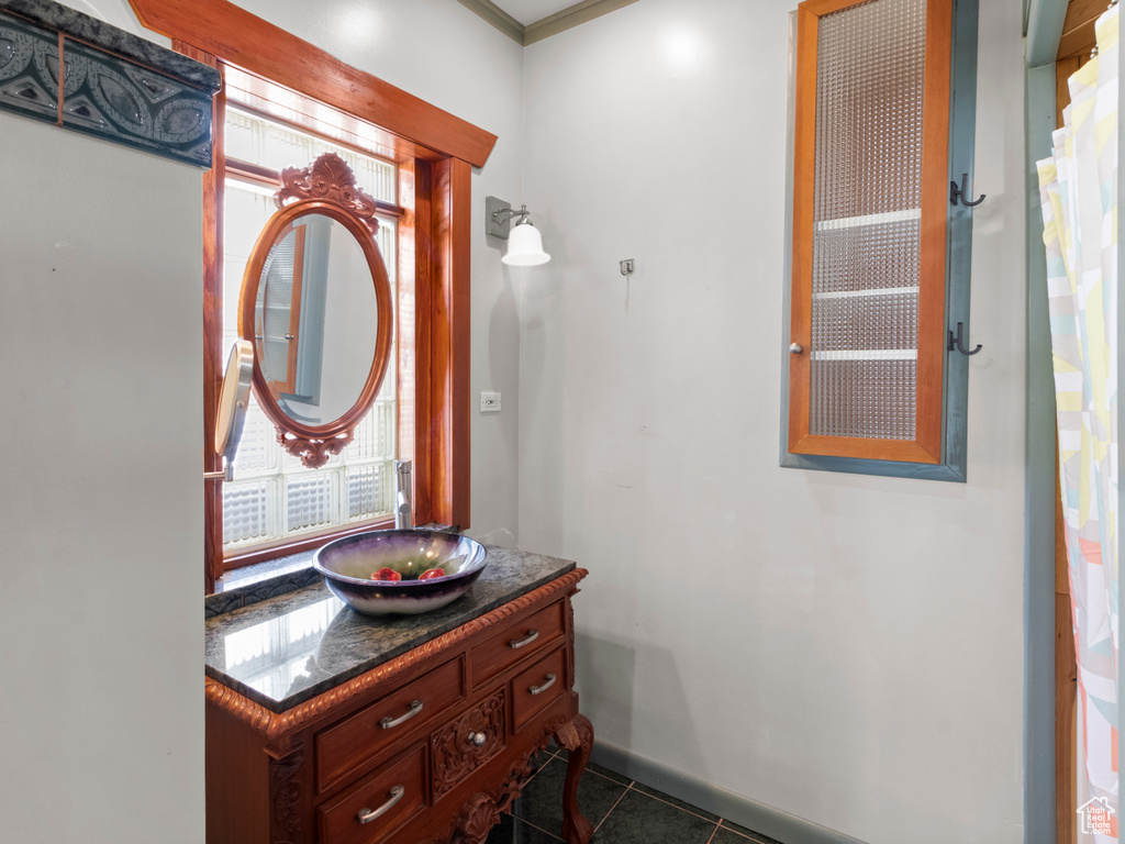Bathroom with tile patterned floors and vanity