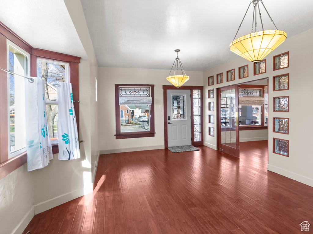 Entryway with baseboards and wood finished floors