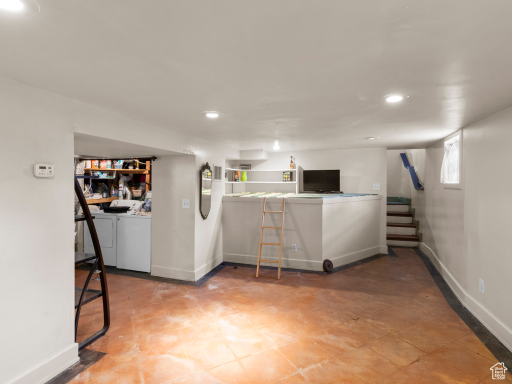 Interior space featuring washer and clothes dryer, recessed lighting, baseboards, and stairs