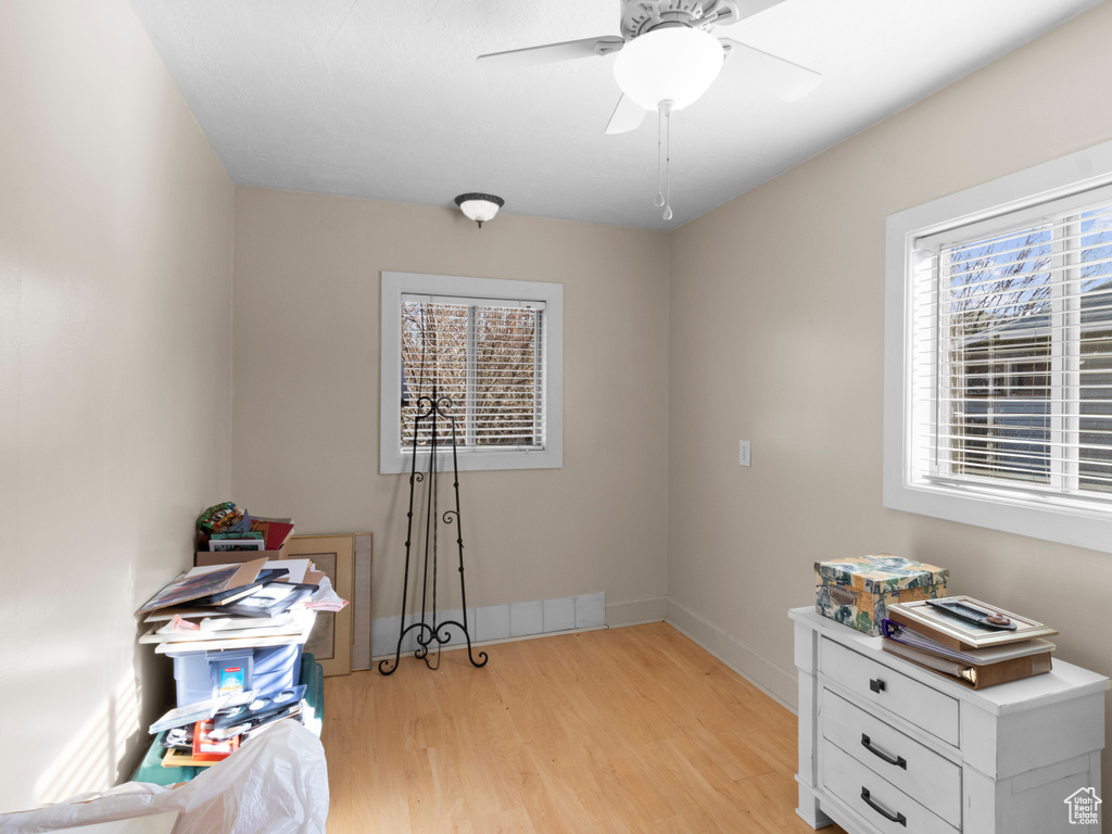 Misc room with light wood-type flooring, ceiling fan, and baseboards