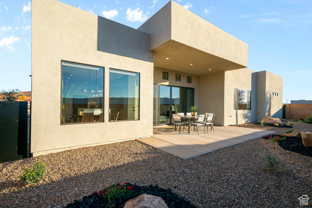 Back of property featuring a patio and stucco siding