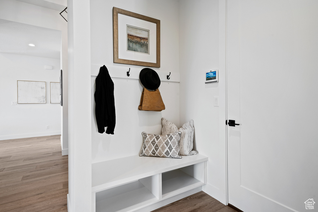 Mudroom with wood finished floors and baseboards