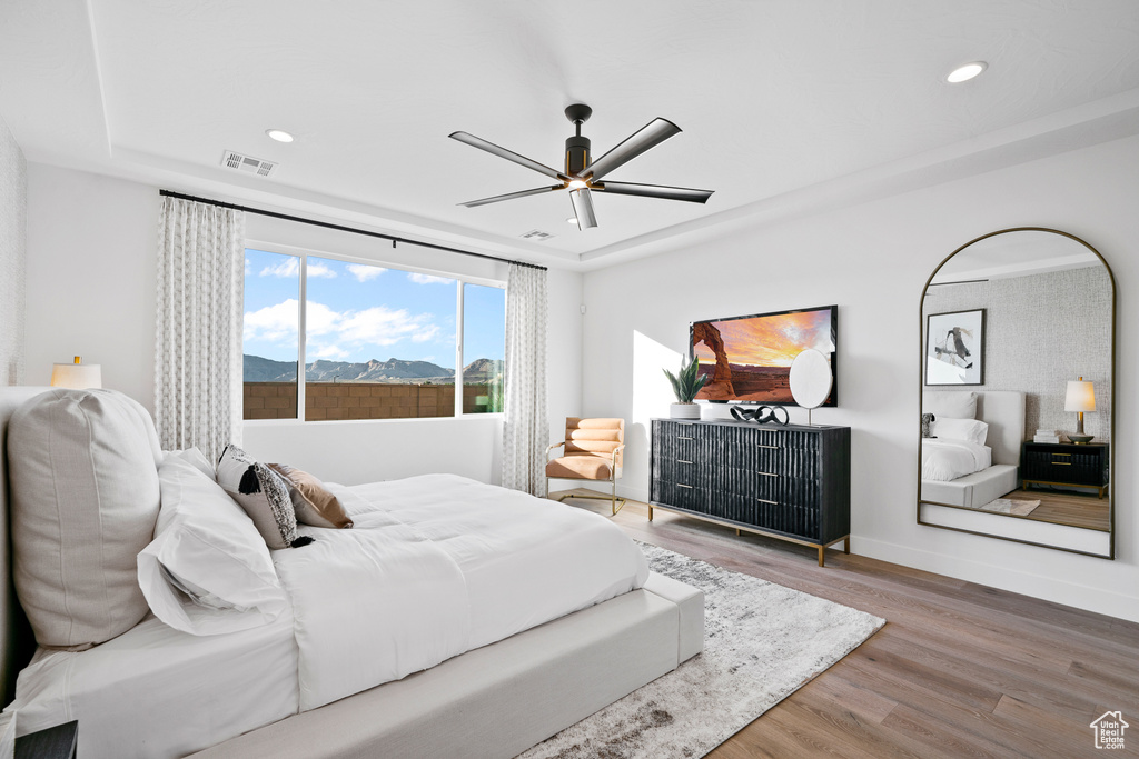 Bedroom with wood finished floors, recessed lighting, baseboards, and ceiling fan