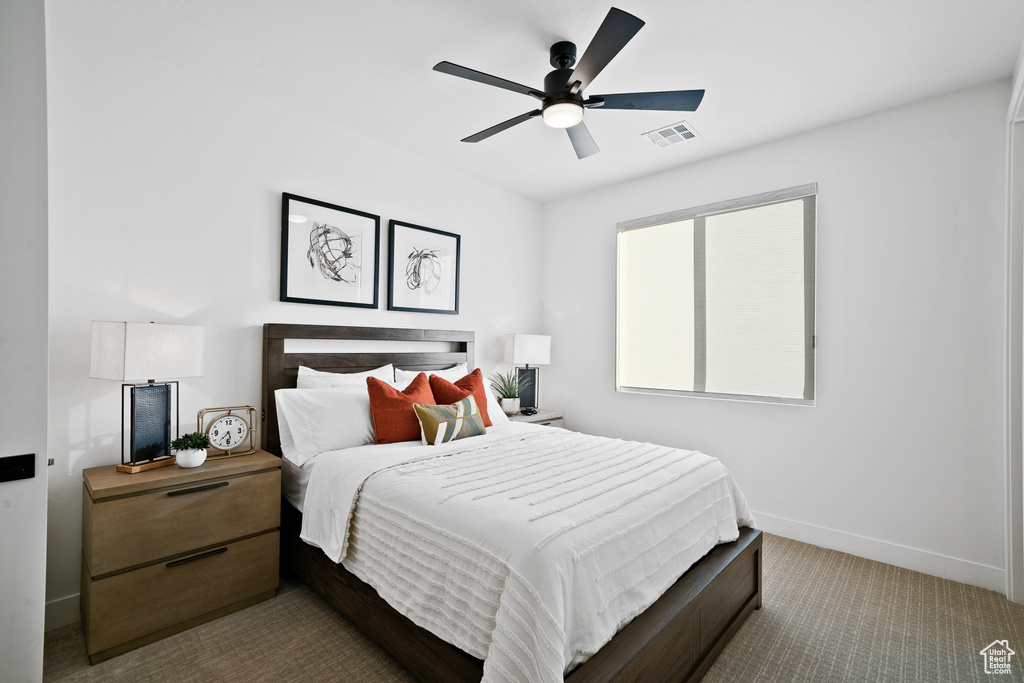 Carpeted bedroom with baseboards and ceiling fan