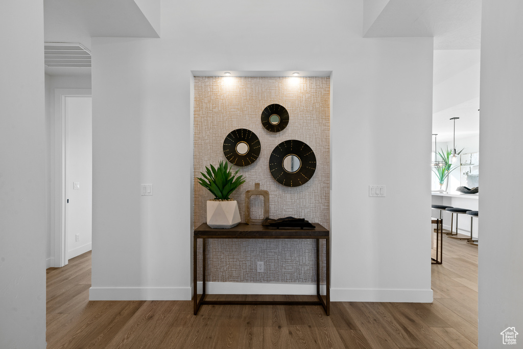 Hallway featuring wood finished floors and baseboards