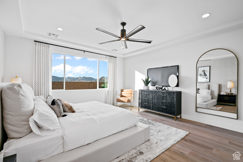 Bedroom with wood finished floors, recessed lighting, baseboards, and ceiling fan