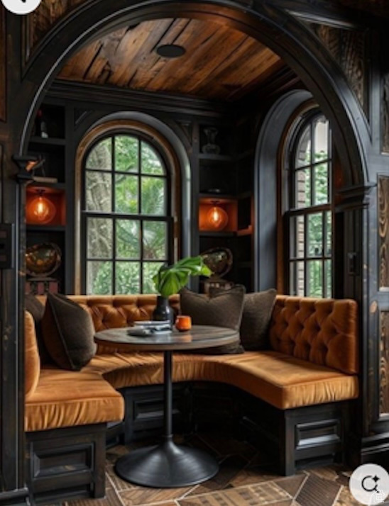 Living area featuring arched walkways, built in features, and a wealth of natural light