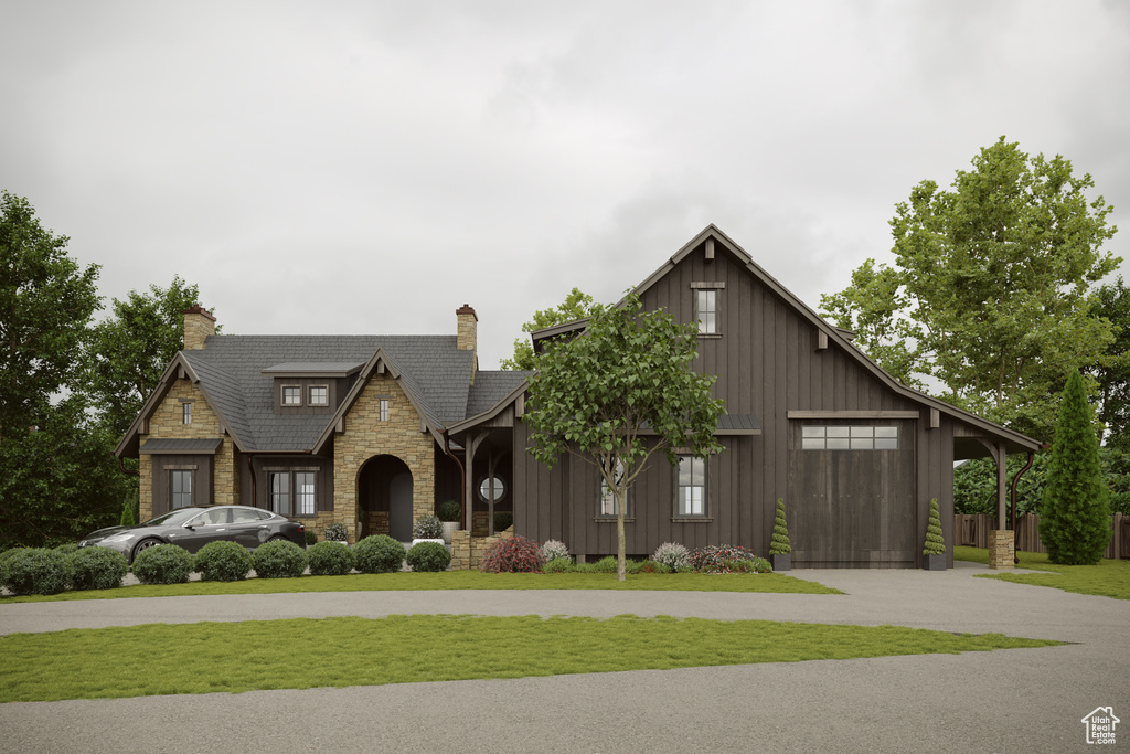 View of front of property featuring board and batten siding, a chimney, a front yard, curved driveway, and stone siding