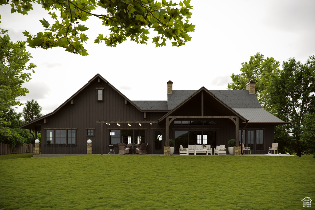 Back of property with an outdoor living space, a yard, a chimney, and a patio