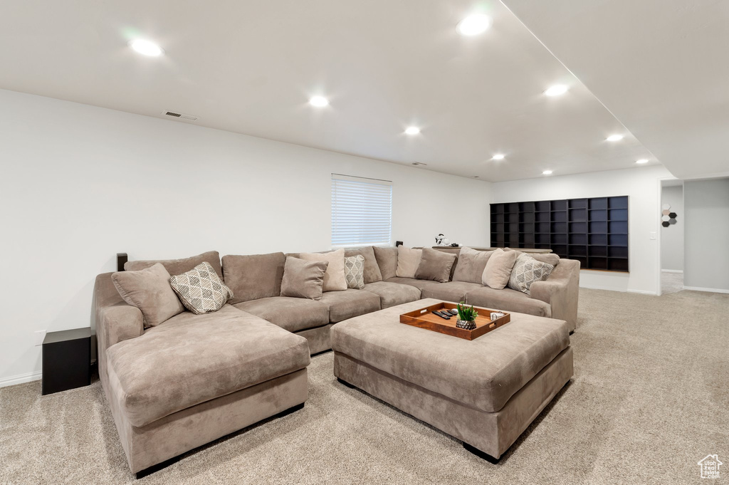 Living area with recessed lighting, visible vents, light colored carpet, and baseboards
