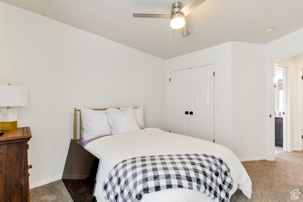 Carpeted bedroom featuring a closet, baseboards, and ceiling fan