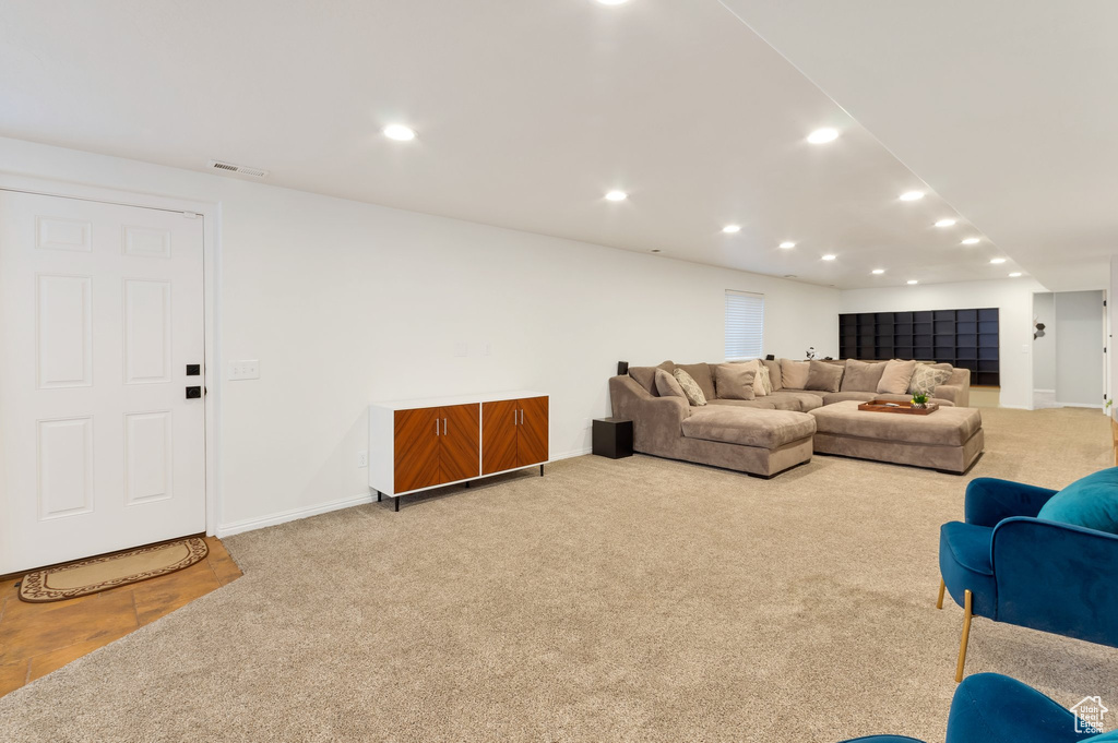 Living area featuring visible vents, baseboards, carpet, and recessed lighting