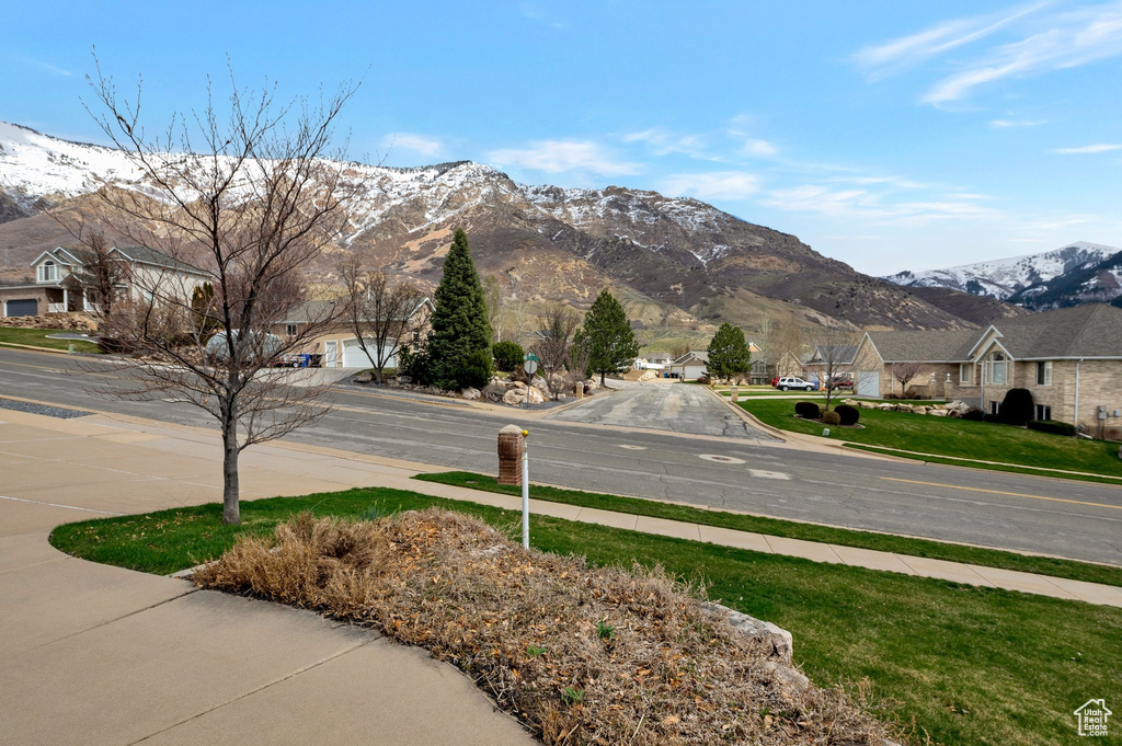 Exterior space featuring a residential view, a mountain view, and sidewalks