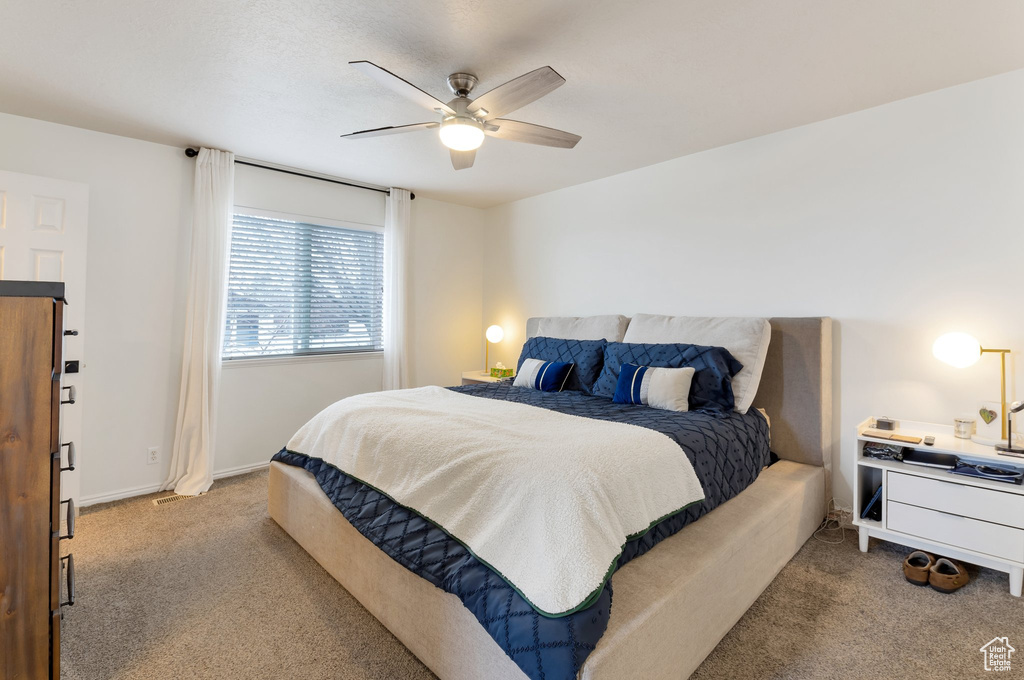 Bedroom with baseboards, a ceiling fan, and carpet floors