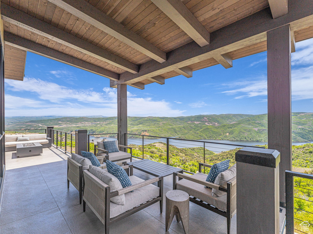 View of patio / terrace featuring a water view and an outdoor living space