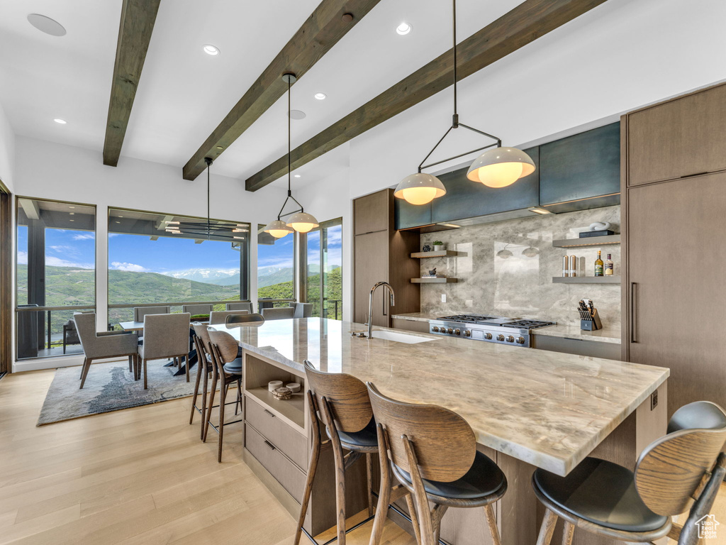 Kitchen with open shelves, a sink, modern cabinets, backsplash, and beamed ceiling