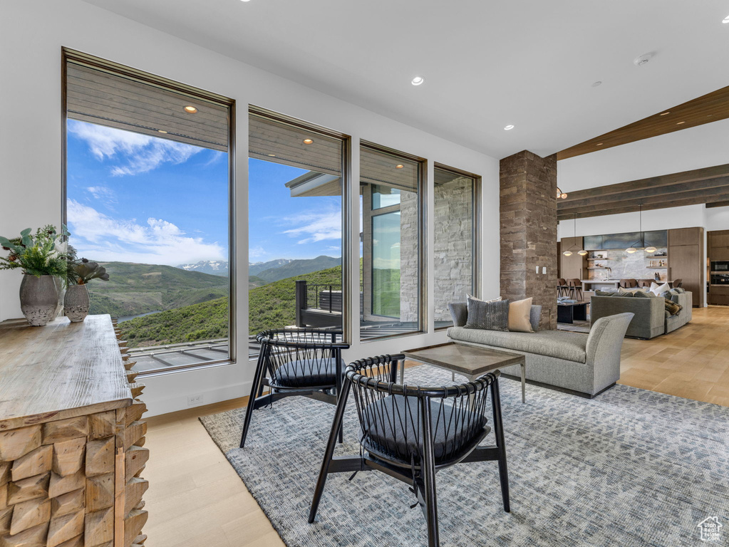 Living room with light wood-style flooring, a mountain view, and recessed lighting