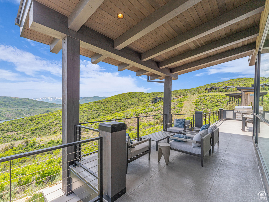 View of patio / terrace with a balcony and a mountain view