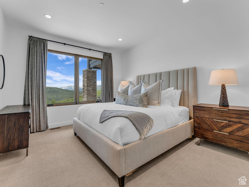 Bedroom with light colored carpet, recessed lighting, and baseboards