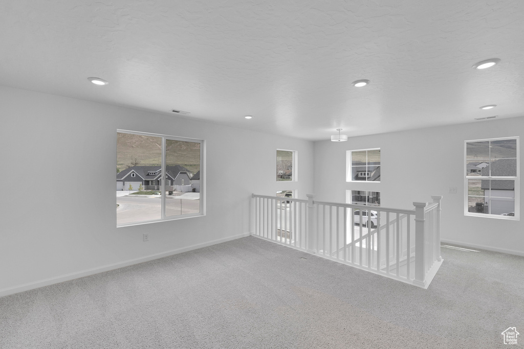 Empty room with carpet flooring, baseboards, and recessed lighting