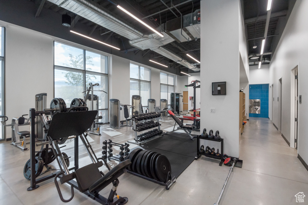 Workout area featuring a towering ceiling