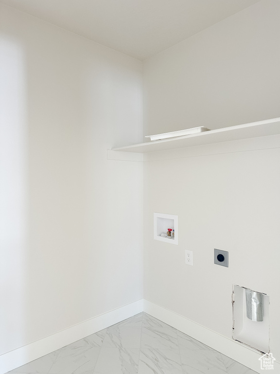Clothes washing area featuring hookup for an electric dryer, hookup for a washing machine, baseboards, and light marble finish floors