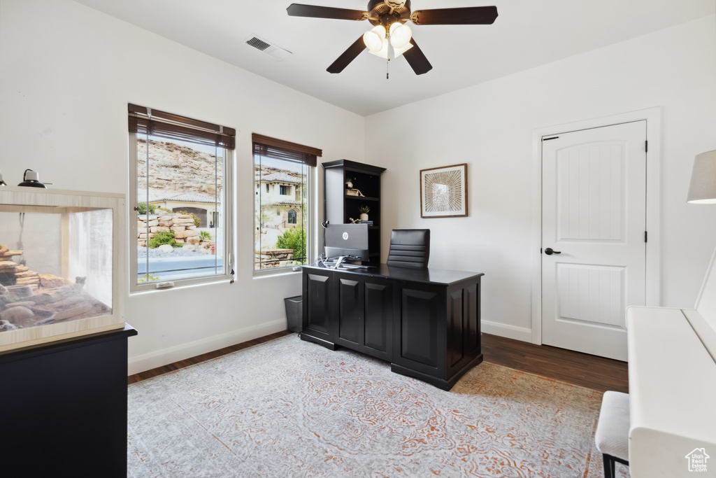 Office area with wood finished floors, ceiling fan, baseboards, and visible vents