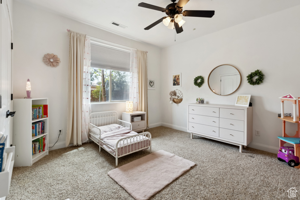 Bedroom featuring visible vents, baseboards, ceiling fan, and light colored carpet