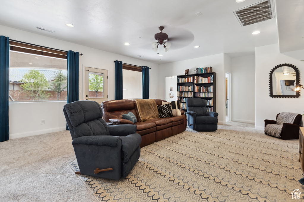 Living area with carpet, visible vents, and recessed lighting