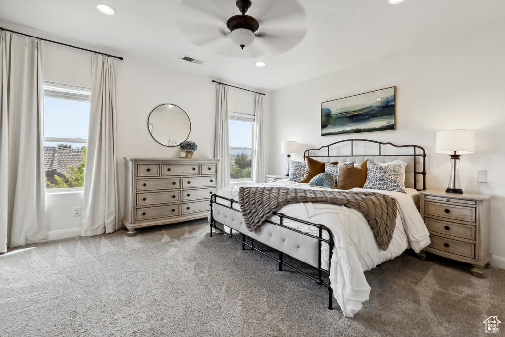 Bedroom with recessed lighting, carpet flooring, visible vents, and multiple windows